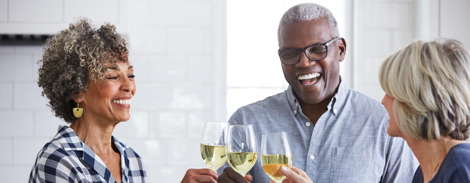 a few people toasting wine glasses